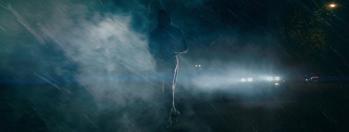 A man on the street is enveloped in smoke created by Rosco Fog Machines.