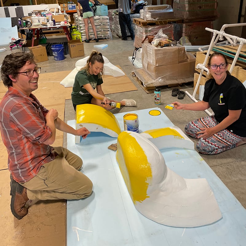 Painting a foam helicopter adaptive costume for children with disabilities.