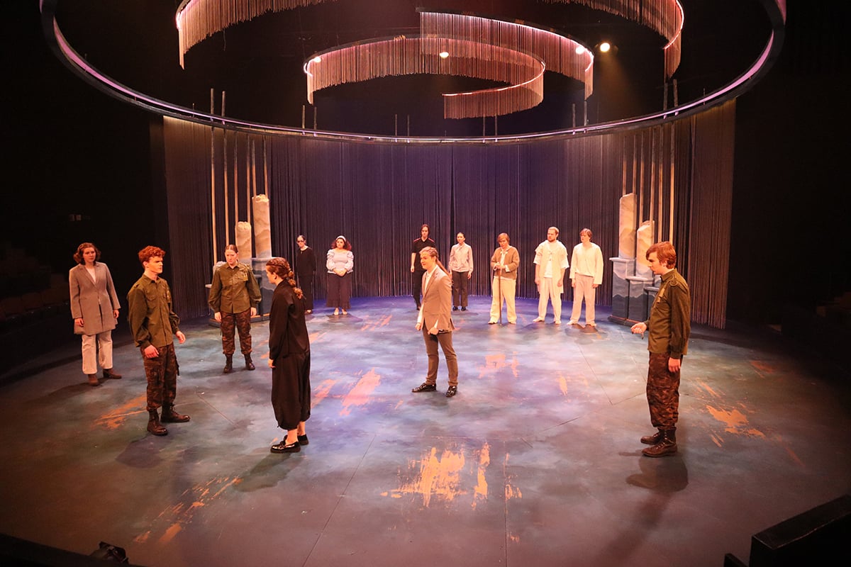 Off Broadway Gold paint highlights on the stage transform into pools of wet neon blood under red light.