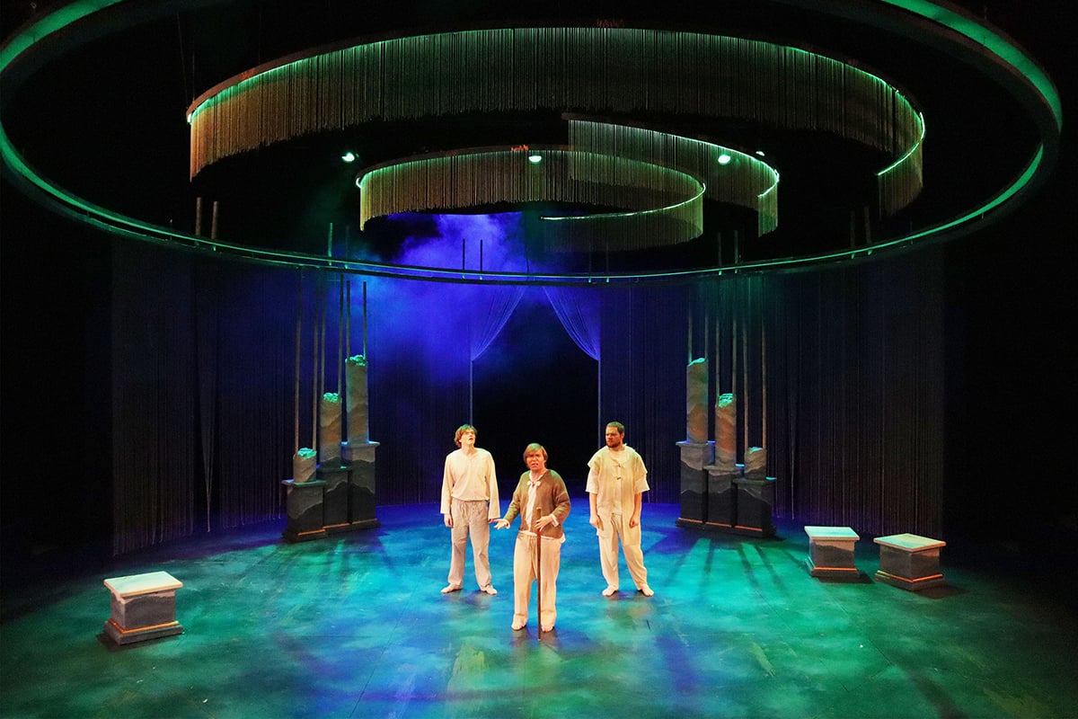 Off Broadway Gold paint highlights on the stage nearly disappear under green light.