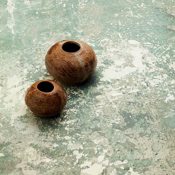 Two pots sit on a textured photo backdrop that was created with Rosco Supersat Paint.