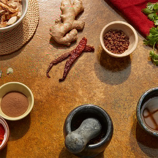 Cooking ingredients sit on top of a textured sandy photography backdrop that was created with Rosco Supersat paint.